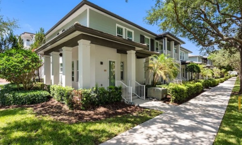 exterior of a dwelling with a sidewalk and trees