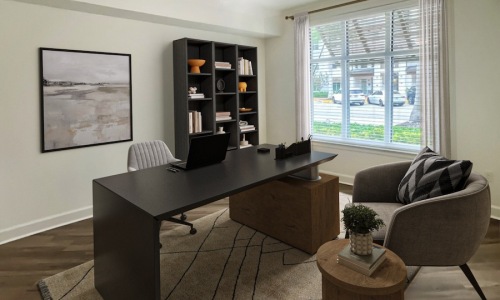 a room with a desk, window and chair