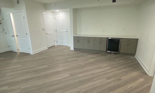 a room with wood-style flooring and grey cabinets
